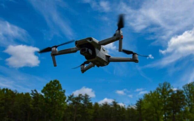 Drone capturing multispectral NDVI imagery over agricultural field trial, North Zone